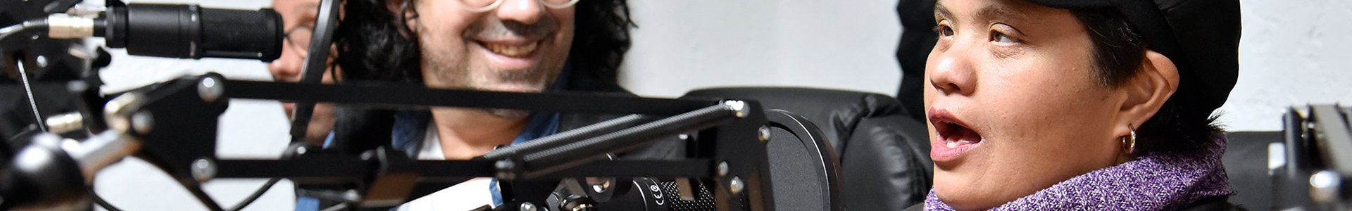 Person speaking into a studio microphone