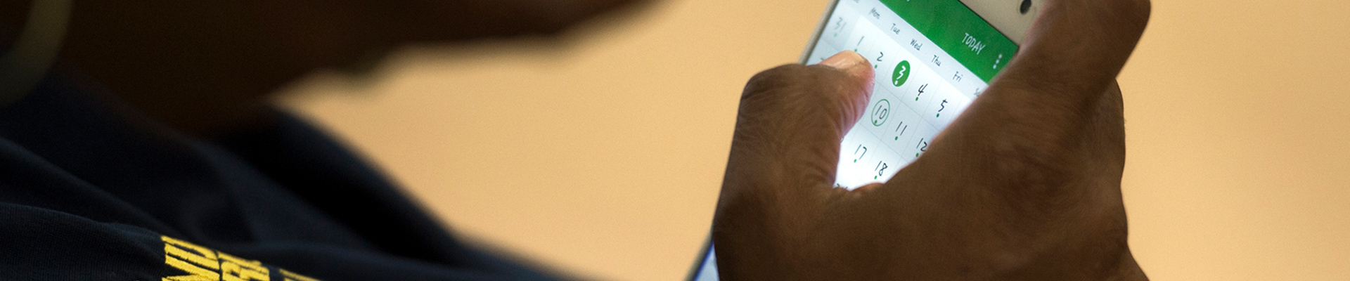 Hand holding a phone with a calendar app open