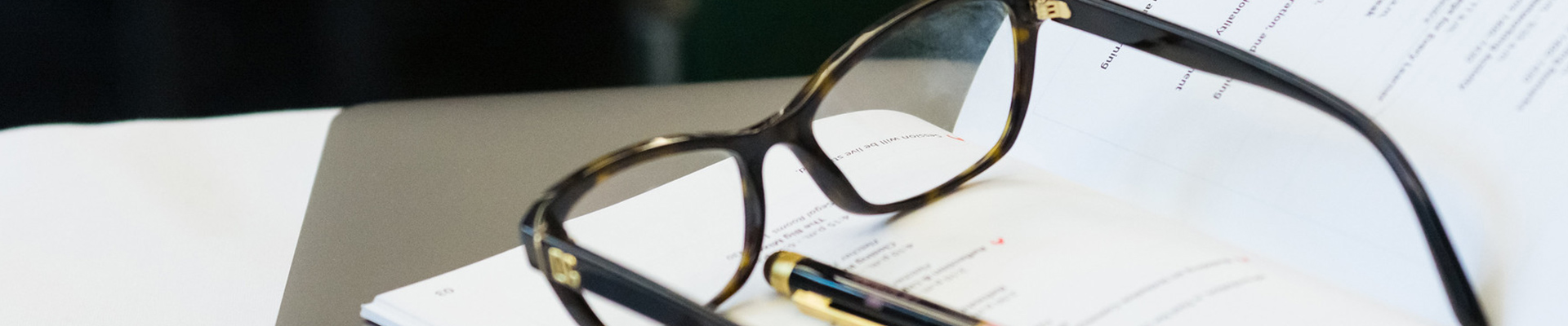 Glasses laying on an open notebook