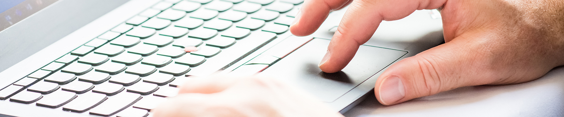 Hand on a laptop trackpad