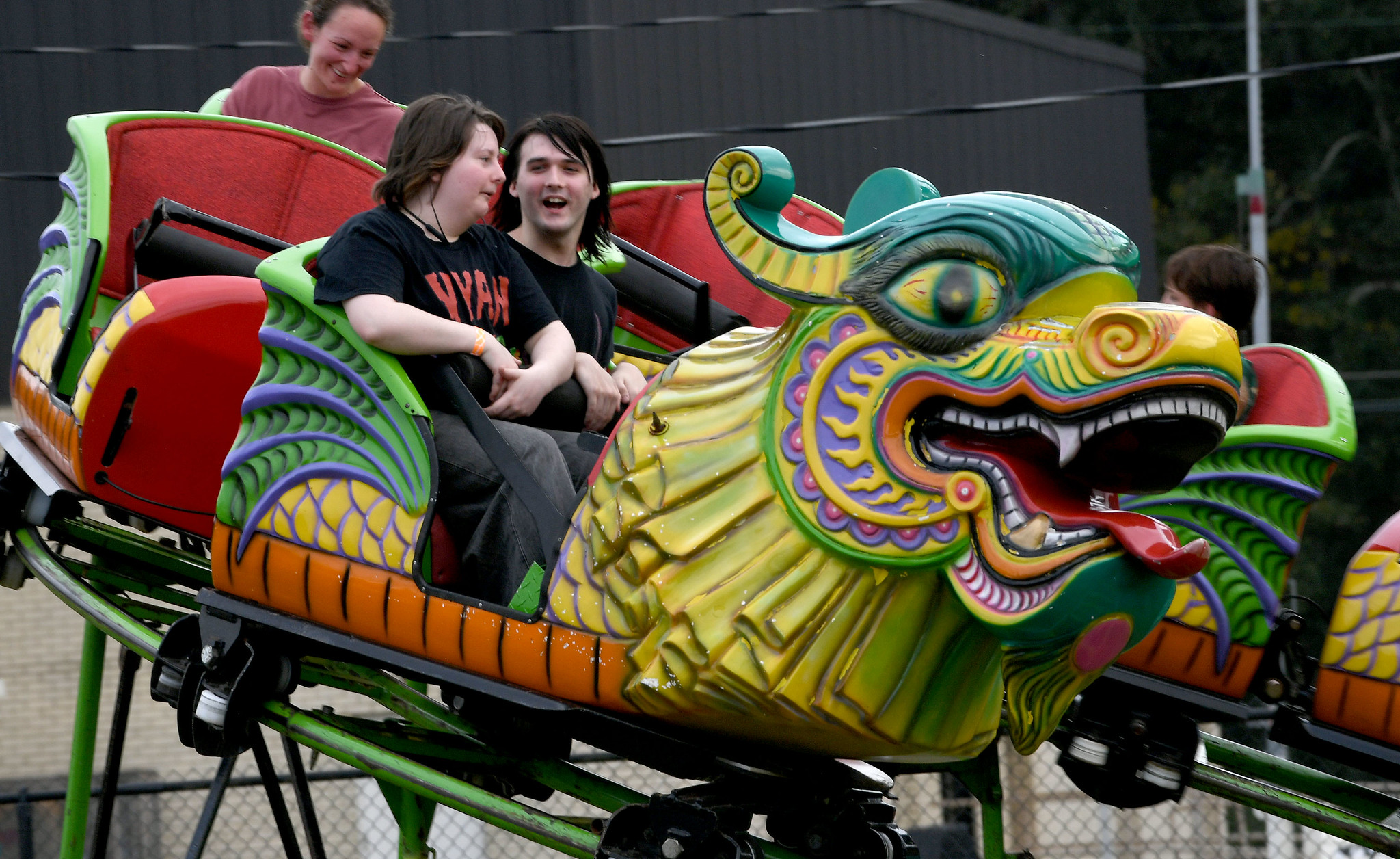 Two teens riding an amusement park ride.