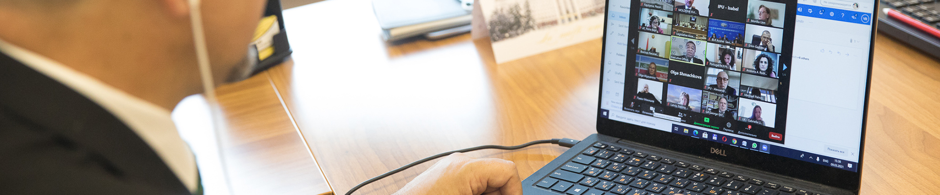 Person using a laptop to participate in an online webinar