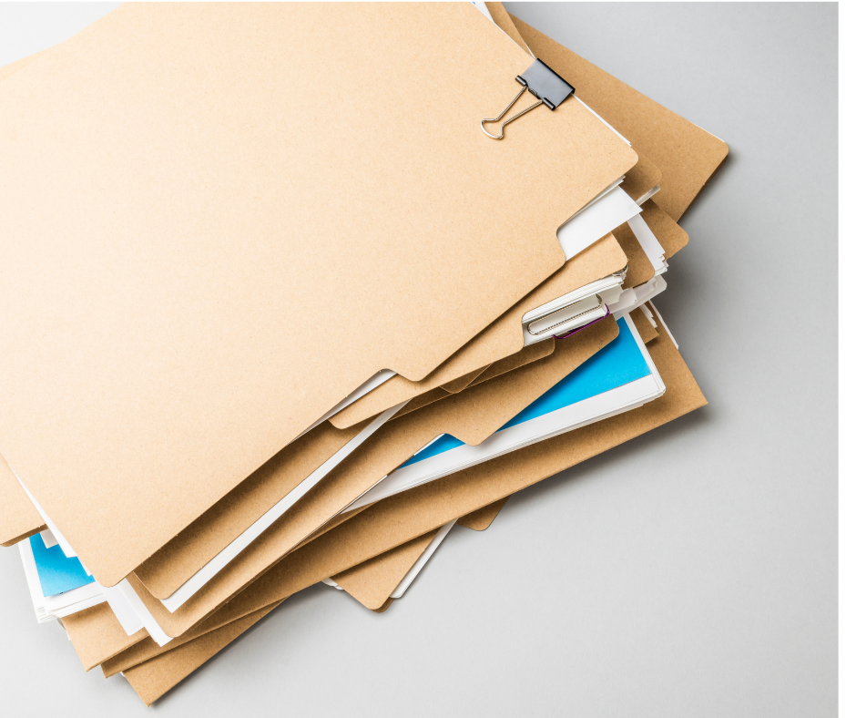 Stack of paper case files secured with binder clips.